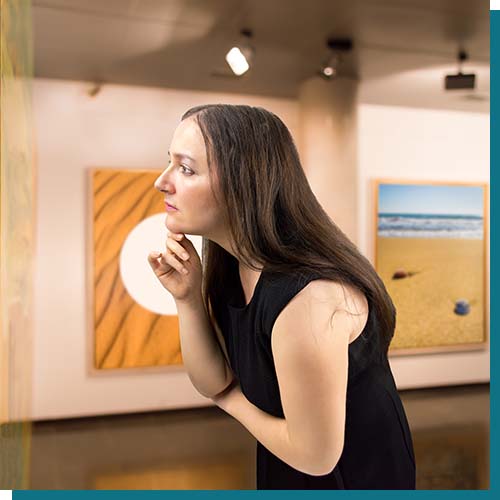 a woman looking at an art piece while being on vacation